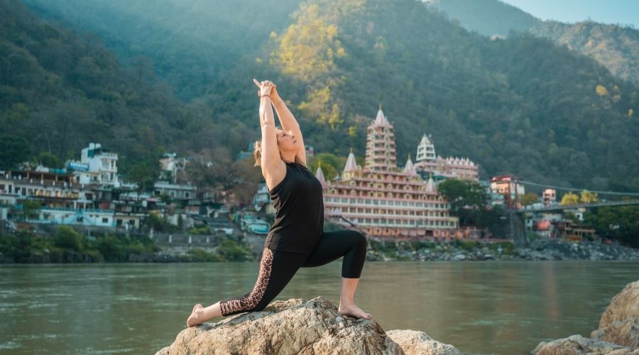 Exercising on a Rocky Riverbank of the Ganges