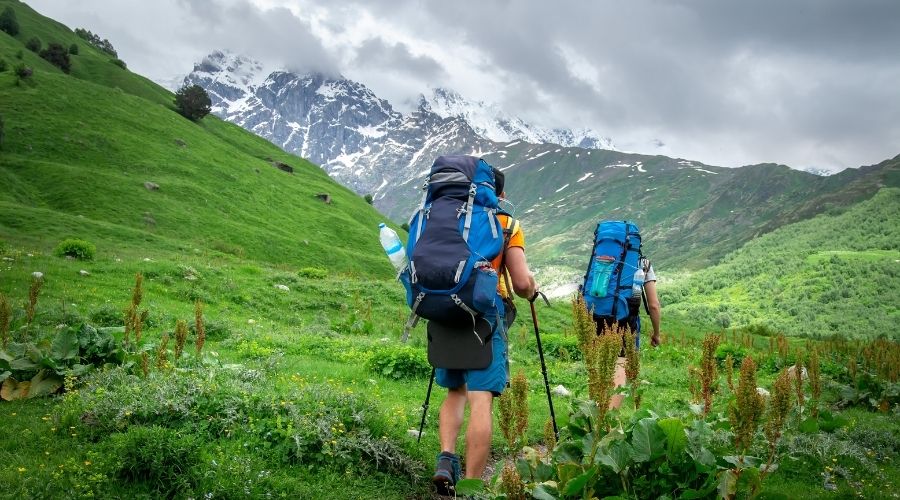 Trekking in mountains. Mountain trail with tourists. Svaneti mountains trekking